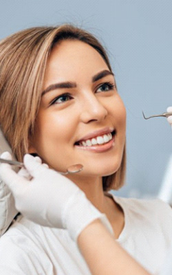 a patient smiling while visiting her dentist