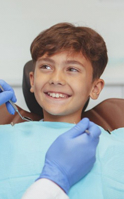 a child patient smiling during his dental visit