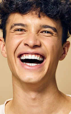 a man smiling with bright teeth