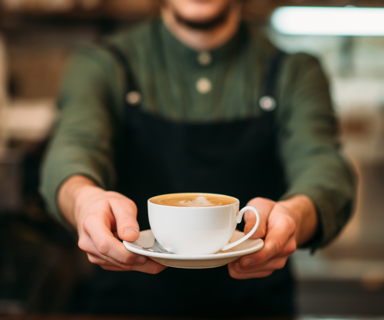 Barista handing coffee