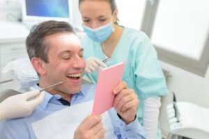 Man smiling after his cosmetic dental treatment